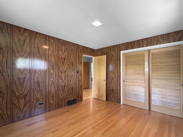 1048 Marshall Dr, Des Plaines, IL 60016 - unfurnished bedroom featuring a closet, wood finished floors, and wooden walls