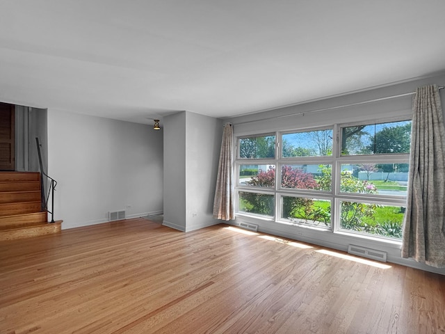 1048 Marshall Dr, Des Plaines, IL 60016 - unfurnished room featuring plenty of natural light, wood finished floors, stairs, and baseboards