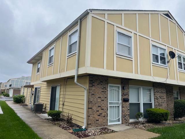 20120 Ash Ln Unit 0, Lynwood, IL 60411 - view of property exterior with brick siding, central air condition unit, and board and batten siding