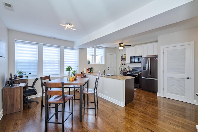 2840 W Glenlake St Unit 3D, Chicago, IL 60659 - dining room with dark wood finished floors, ceiling fan, and baseboards