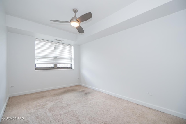 unfurnished room with carpet floors, baseboards, and a ceiling fan