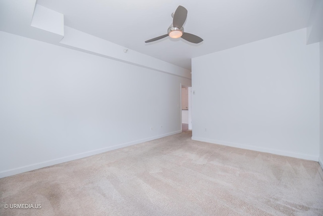 unfurnished room featuring carpet flooring, a ceiling fan, and baseboards