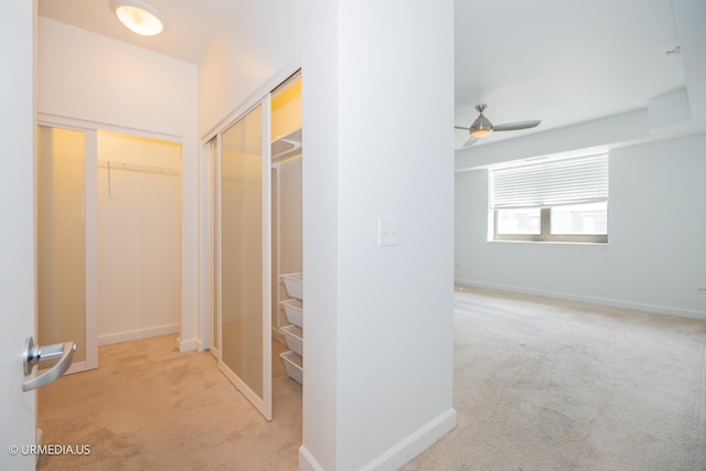 hall with carpet flooring and baseboards