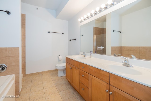 full bath with tile patterned flooring, double vanity, a bath, a tile shower, and toilet