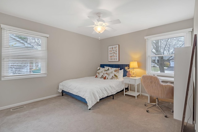 carpeted bedroom featuring baseboards and ceiling fan