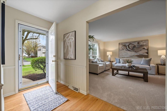 554 Carriage Hill Rd, Naperville, IL 60565 - entrance foyer with light wood finished floors and wainscoting