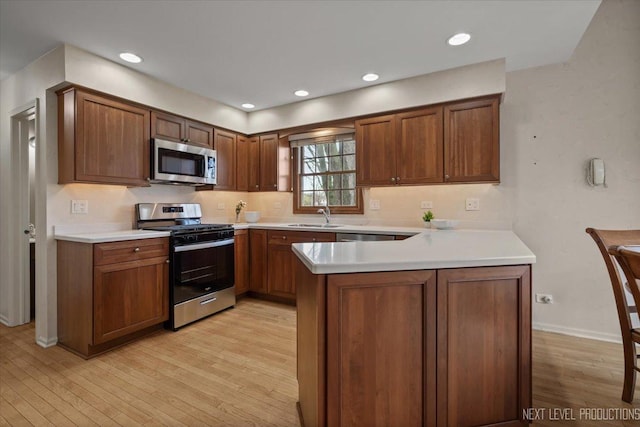 554 Carriage Hill Rd, Naperville, IL 60565 - kitchen featuring appliances with stainless steel finishes, a sink, light wood-style floors, a peninsula, and light countertops