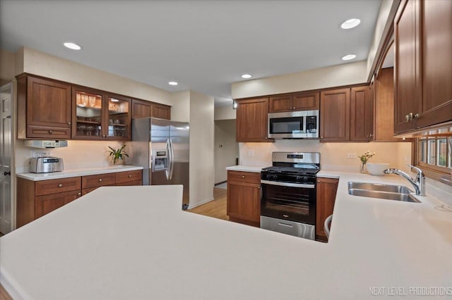 554 Carriage Hill Rd, Naperville, IL 60565 - kitchen featuring appliances with stainless steel finishes, a sink, light countertops, glass insert cabinets, and recessed lighting