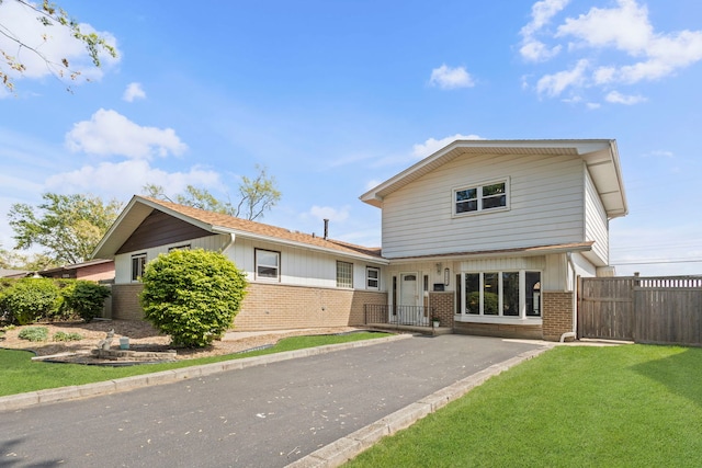 view of front of property with brick siding and driveway
