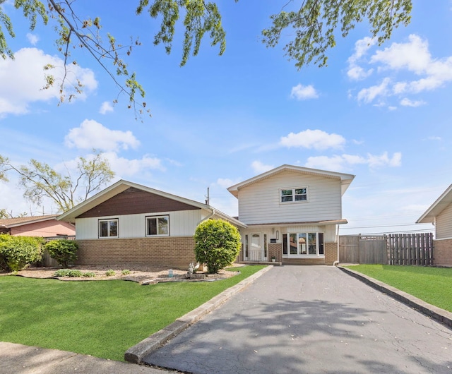 view of front of house featuring brick siding and asphalt driveway