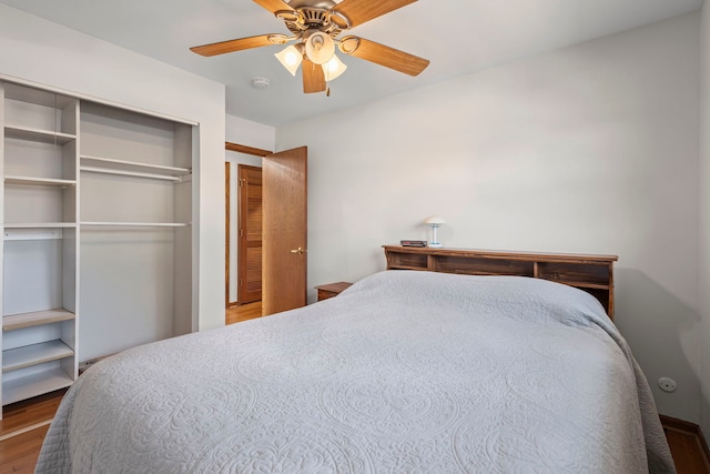 bedroom featuring wood finished floors, a closet, and a ceiling fan