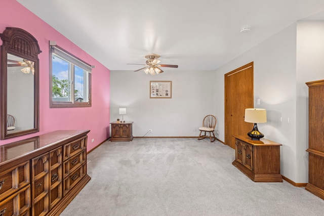 sitting room with ceiling fan, carpet flooring, and baseboards