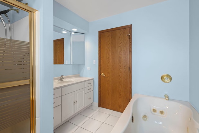 bathroom featuring a whirlpool tub, tile patterned flooring, and vanity