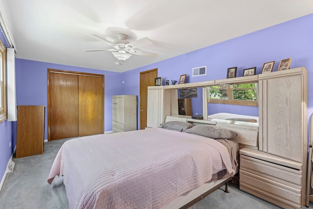 carpeted bedroom with a closet and a ceiling fan