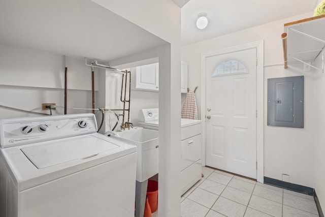 clothes washing area featuring electric panel, washer and clothes dryer, and light tile patterned flooring