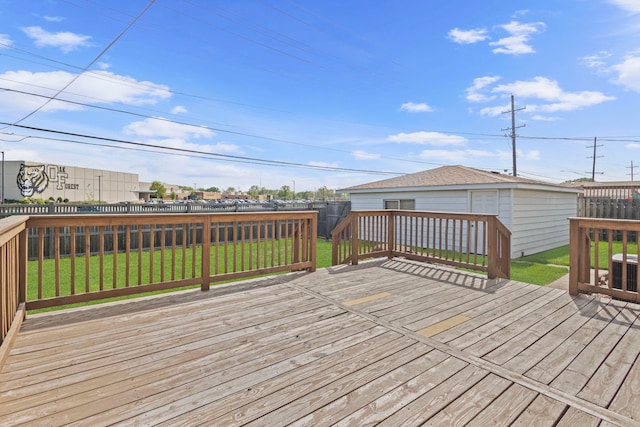 wooden deck featuring an outdoor structure and central AC unit