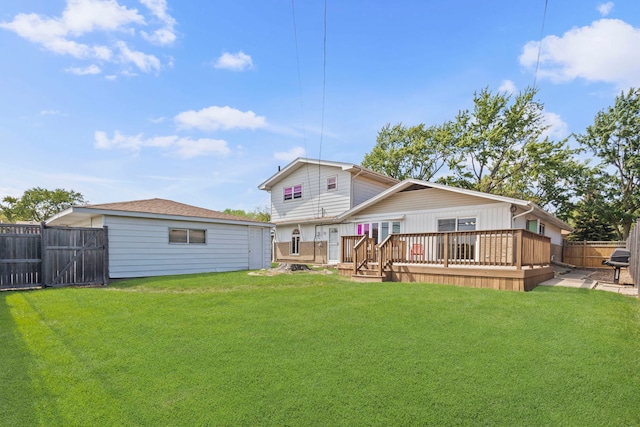 rear view of property featuring a deck and a gate