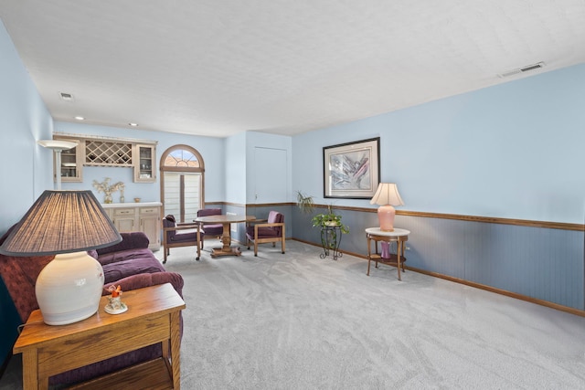 living room with wainscoting and carpet floors
