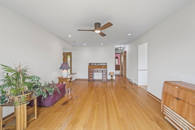 living room featuring a ceiling fan, light wood-type flooring, baseboards, and recessed lighting