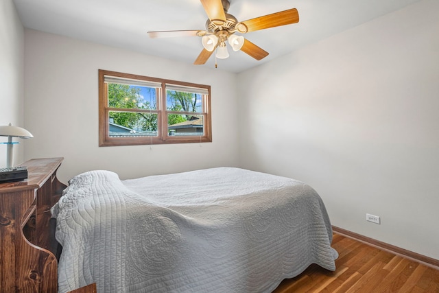 bedroom with wood finished floors, baseboards, and ceiling fan