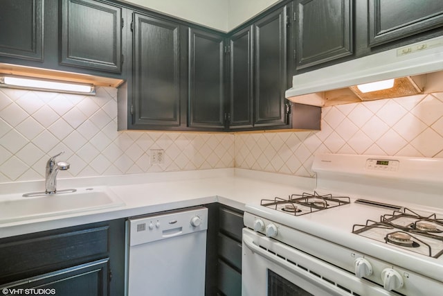 941 N NW Hwy Unit 2B, Park Ridge, IL 60068 - kitchen with white appliances, under cabinet range hood, a sink, light countertops, and dark cabinets
