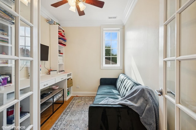 518 Winnetka Ave Unit 203, Winnetka, IL 60093 - living area with crown molding, wood finished floors, baseboards, and ceiling fan
