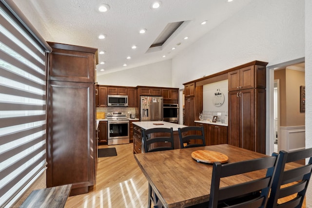 396 Jervey Ln, Bartlett, IL 60103 - dining room featuring light wood finished floors, vaulted ceiling, and recessed lighting