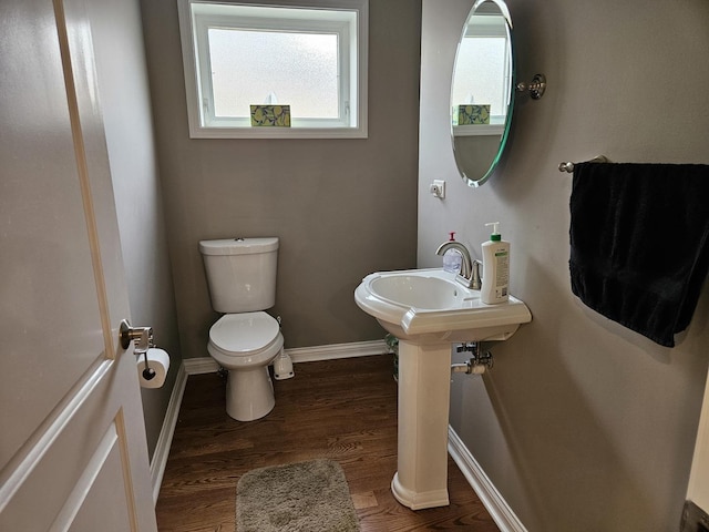 6710 W Harts Rd, Niles, IL 60714 - half bath with toilet, healthy amount of natural light, baseboards, and wood finished floors
