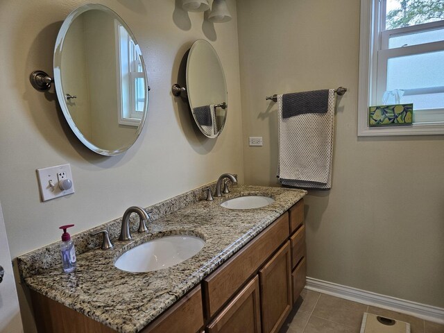 6710 W Harts Rd, Niles, IL 60714 - bathroom with baseboards, tile patterned flooring, and double vanity