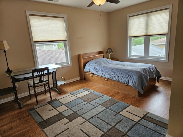 6710 W Harts Rd, Niles, IL 60714 - bedroom featuring multiple windows, baseboards, wood finished floors, and ceiling fan