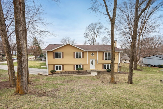 raised ranch with a front yard