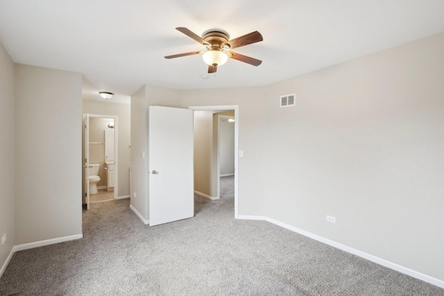 unfurnished bedroom featuring carpet flooring, baseboards, connected bathroom, and ceiling fan