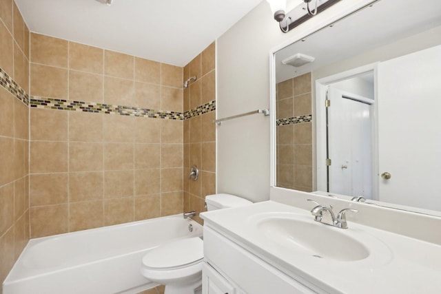 bathroom featuring toilet, tub / shower combination, and vanity