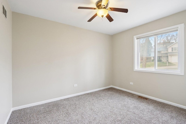 carpeted empty room with baseboards and ceiling fan