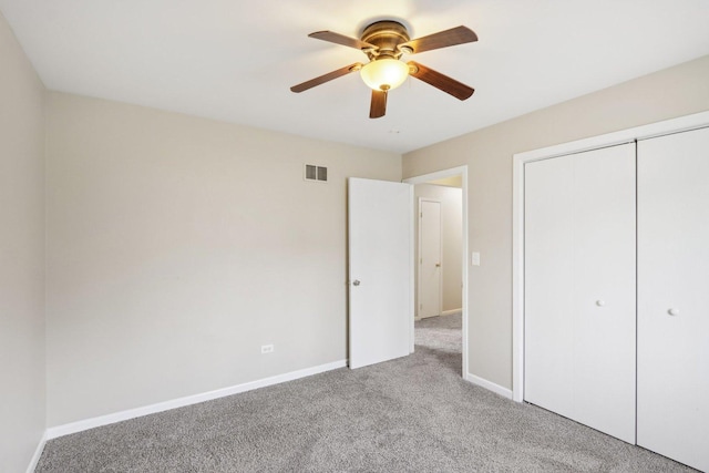 unfurnished bedroom with carpet, baseboards, a closet, and ceiling fan