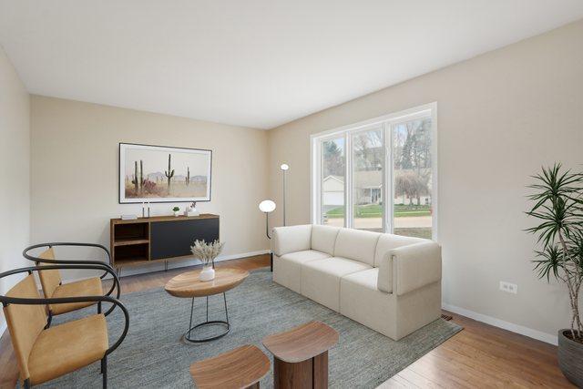 living room featuring wood finished floors and baseboards