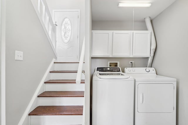 laundry area featuring washing machine and dryer and cabinet space
