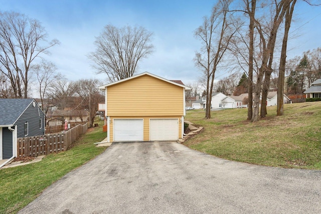 garage with driveway and a residential view