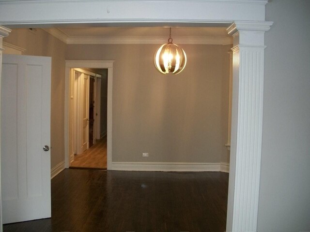 7421 S Eberhart Ave, Chicago, IL 60619 - empty room featuring a chandelier, baseboards, wood finished floors, ornate columns, and crown molding
