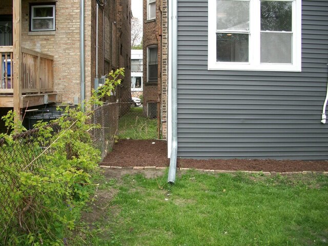 7421 S Eberhart Ave, Chicago, IL 60619 - exterior view of fence and brick siding
