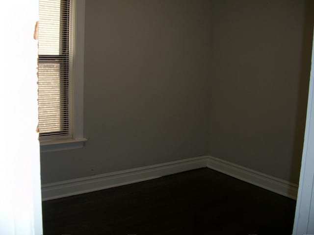 7421 S Eberhart Ave, Chicago, IL 60619 - empty room with baseboards and dark wood-type flooring