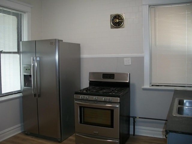 7421 S Eberhart Ave, Chicago, IL 60619 - kitchen featuring appliances with stainless steel finishes, wood finished floors, dark countertops, and baseboards