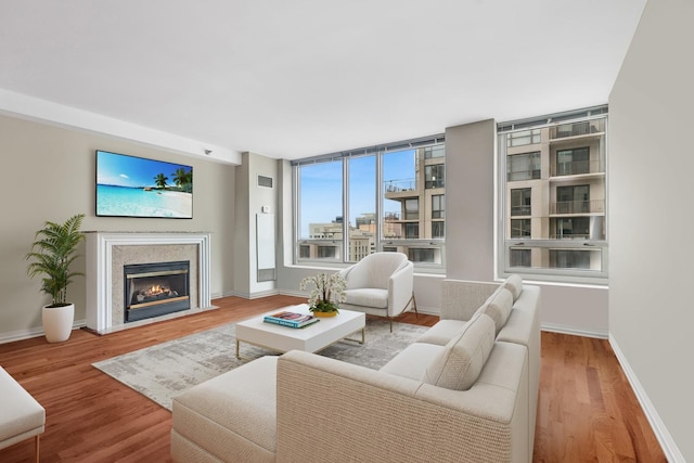 33 W Ontario St Unit 25H, Chicago, IL 60654 - living room with wood finished floors, baseboards, and a glass covered fireplace