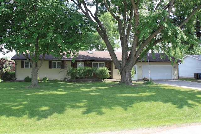 ranch-style home with an attached garage, a front yard, concrete driveway, and central AC
