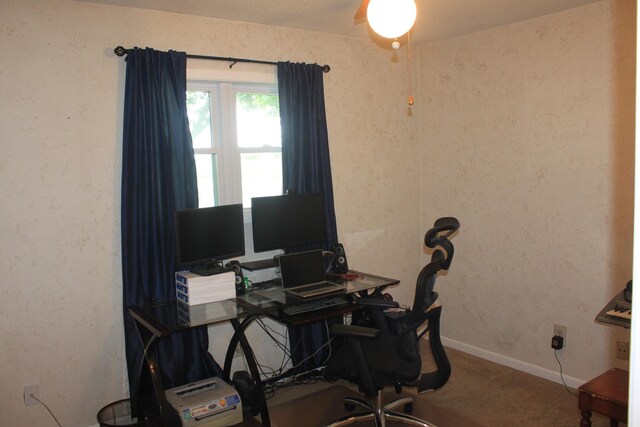 carpeted office featuring baseboards and ceiling fan