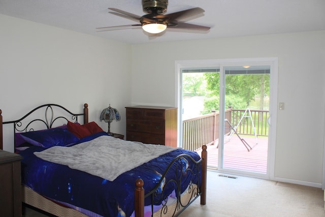 carpeted bedroom with access to exterior, a ceiling fan, and baseboards