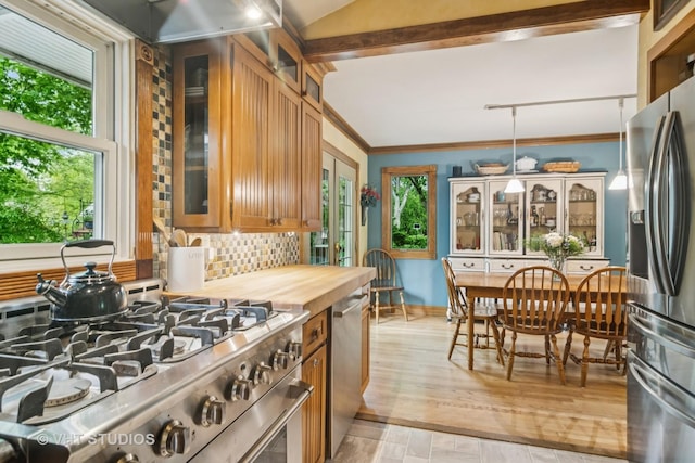 90 Golfview Rd, Lake Zurich, IL 60047 - kitchen with stainless steel appliances, backsplash, plenty of natural light, crown molding, and brown cabinets