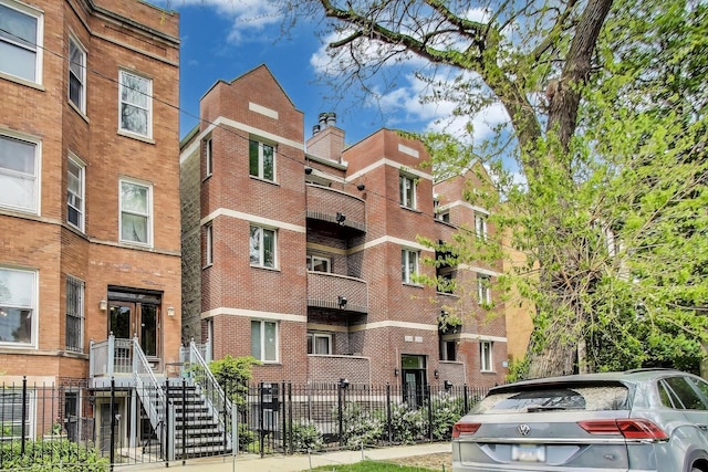 2136 W Evergreen Ave Unit 3B, Chicago, IL 60622 - view of apartment building / complex with a fenced front yard