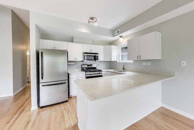 2136 W Evergreen Ave Unit 3B, Chicago, IL 60622 - kitchen with appliances with stainless steel finishes, a peninsula, light wood-type flooring, and baseboards