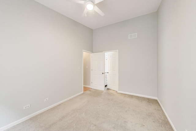 2136 W Evergreen Ave Unit 3B, Chicago, IL 60622 - unfurnished room featuring light carpet, baseboards, a ceiling fan, and a towering ceiling